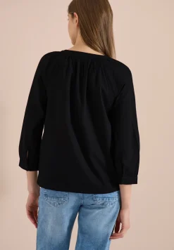 Blouse à manches 3/4 avec col fendu en couleur unie