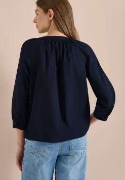 Blouse à manches 3/4 avec col fendu en couleur unie