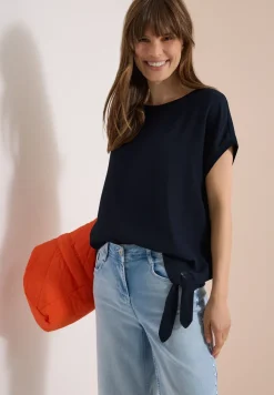Blouse avec col rond et détail de nœuds