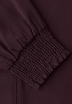 Blouse avec poignets smockés