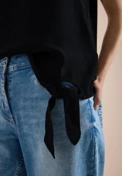 Blouse avec col rond et détail de nœuds