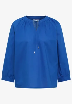 Blouse à manches 3/4 avec col fendu en couleur unie