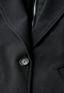 Manteau à revers avec incrustation
